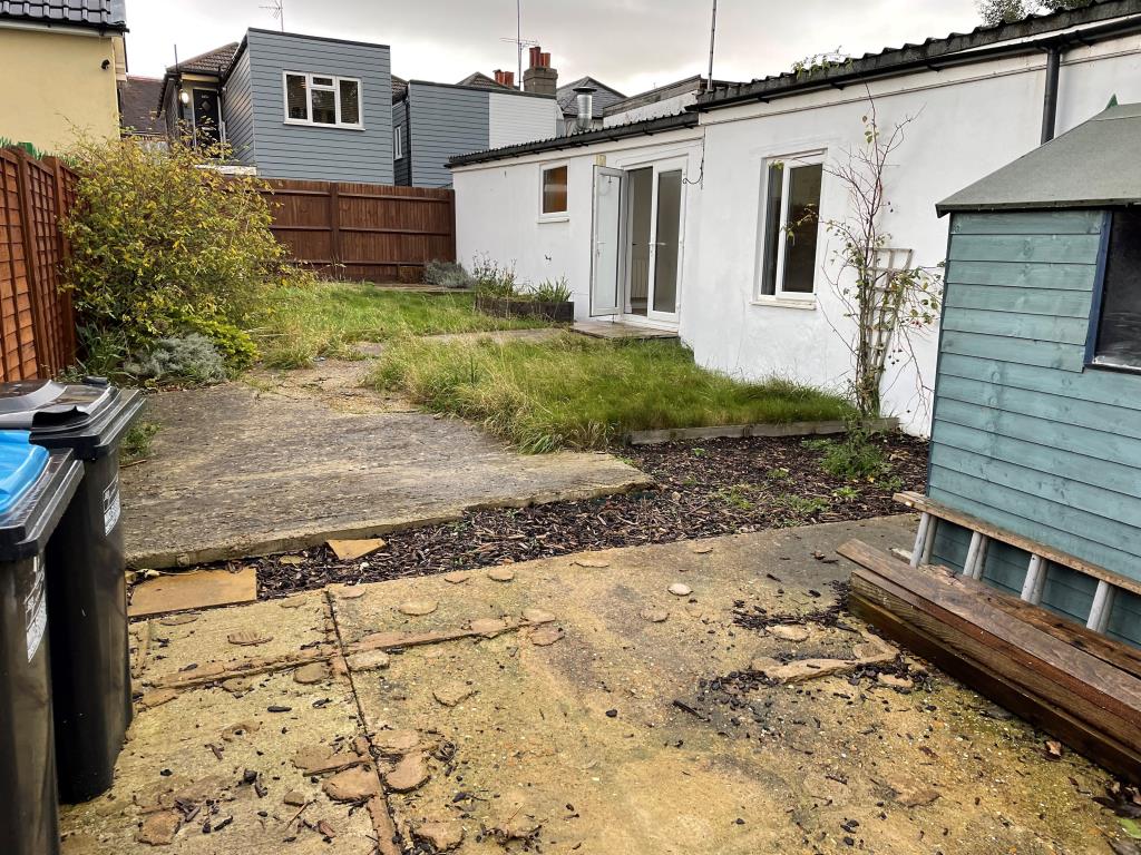 Lot: 145 - DETACHED BUNGALOW IN TOWN CENTRE - View of garden from south with lawn and paved area